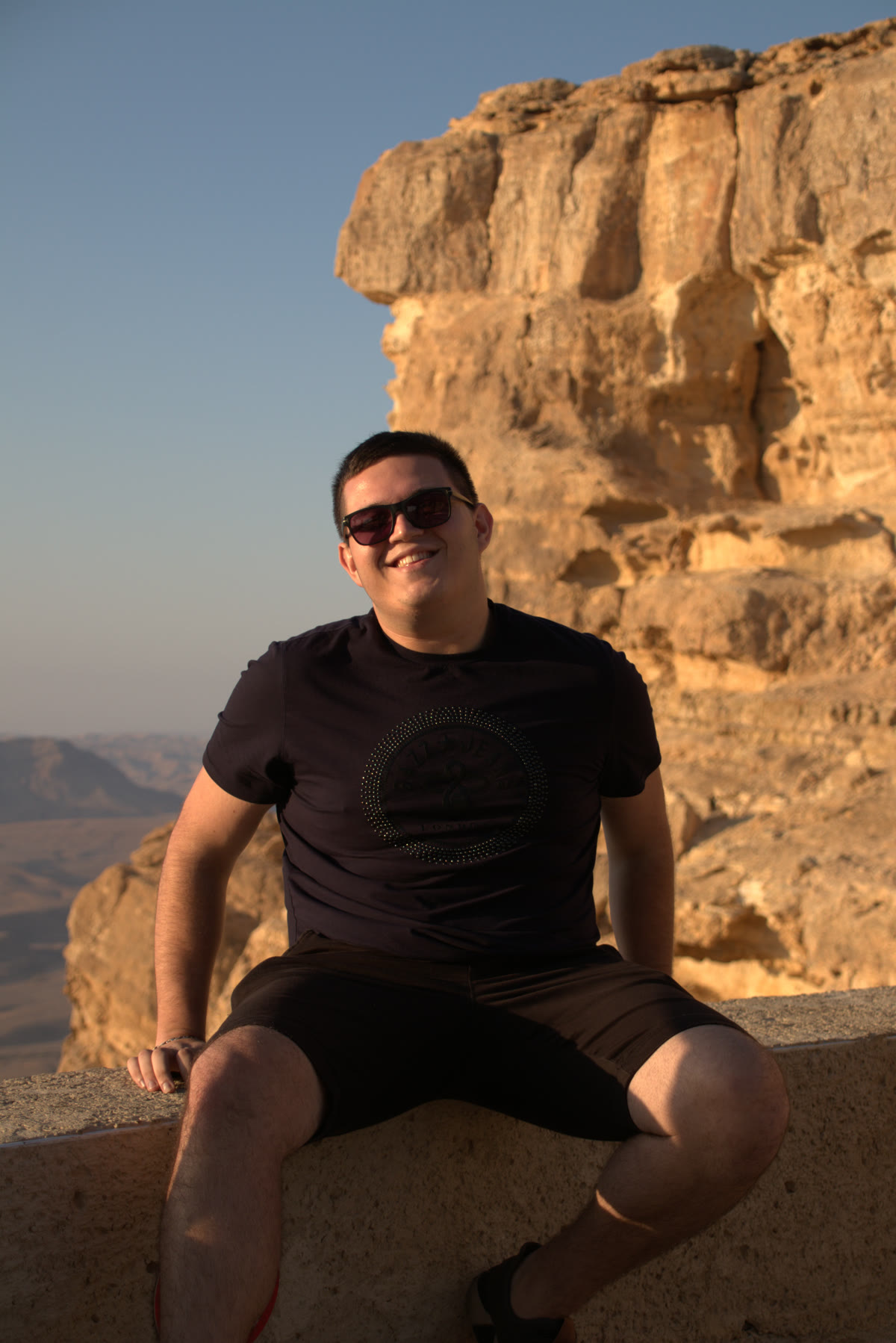 Alexander Aluf sitting outdoors at Makhtesh Ramon, Israel