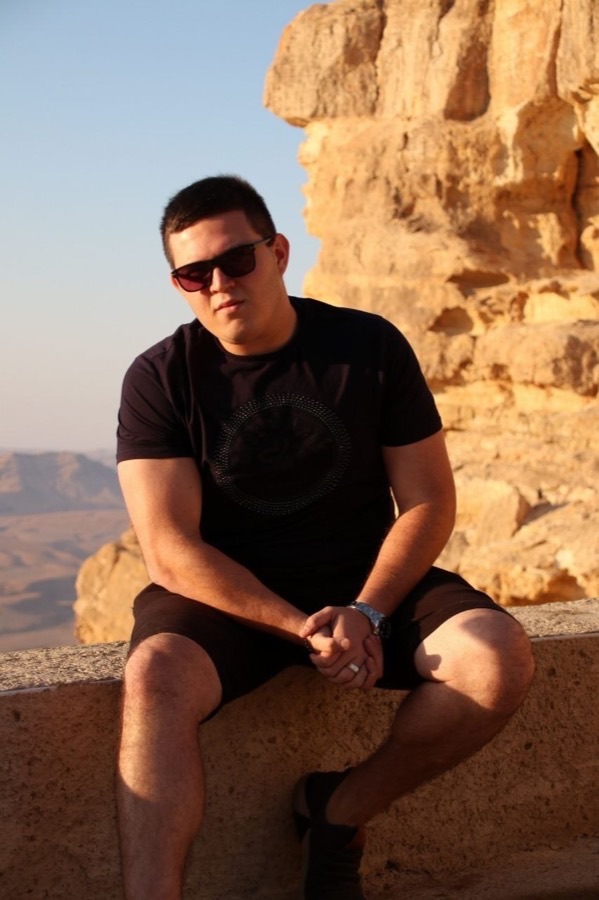 Alexander Aluf seated outdoors at Makhtesh Ramon, Israel